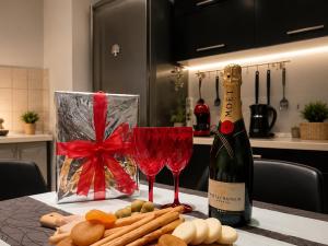 a bottle of champagne and wine glasses on a table at KilkisLuxuryApartment in Kilkis