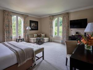 a bedroom with a bed and a living room at Bowood Hotel, Spa, and Golf Resort in Chippenham