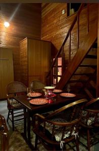 a dining room with a table with chairs and a staircase at LAKE FOREST hug pug in Yamanakako