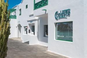 a white building with a sign on the side of it at Apartamentos Celeste in Costa Teguise