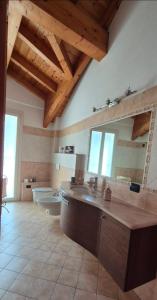 a large bathroom with a sink and a mirror at Casa Cuor Di Leone in Cannobio +42 photos