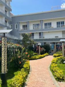 a walkway in front of a building at EM Homes Modern 1-Bedroom Apartment with Pool 15 Minutes from JKIA Airport in Marimbeti
