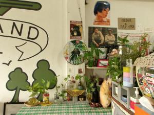 a room with a table with potted plants on it at 11:11 Hostel in Phra Nakhon Si Ayutthaya