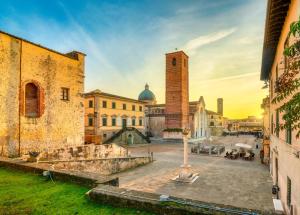 an old building with a clock tower in a city at Villa Alina Family Retreat in Pietrasanta