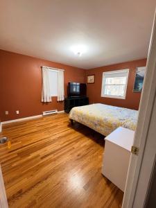 a bedroom with a bed and a television in it at Downtown Halifax near waterfront in Halifax