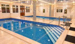 a large swimming pool in a building at HotelVizit in Solotvyno