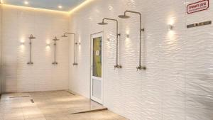 a bathroom with four walk in shower stalls in a building at HotelVizit in Solotvyno +68 photos