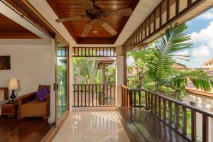 an open porch with a ceiling fan and glass doors at The Sarann Koh Samui, Suites & Villas in Chaweng Noi Beach +144 photos
