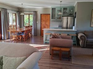 a living room and kitchen with a couch and chairs at Valley View the home with a view in Nottingham Road