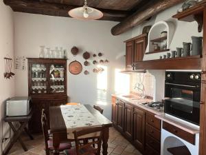 a kitchen with a table and a stove top oven at Casa nel borgo - A Rigadèa in Groppo