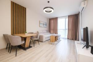 a living room with a couch and a table at River View 1-Bedroom Apartment in Plovdiv
