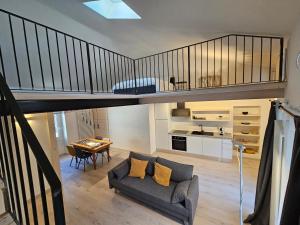 a living room with a loft bed and a couch at La Cereria MARIA in Chiavenna