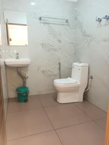 a bathroom with a toilet and a sink at S P Nettoor in Cochin