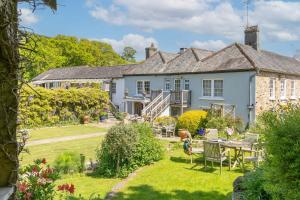 an exterior view of a house with a garden at Barberry Brook - Swimming pool acces in Dittisham