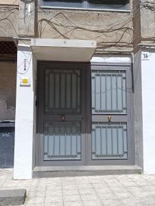 a garage door with two gates on a building at Raggio di sole in Catania
