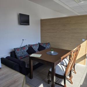 a living room with a table and a couch at THH Apartments in Tallinn
