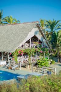 a resort with a large building with a swimming pool at Le Renala Morondava in Morondava +23 photos