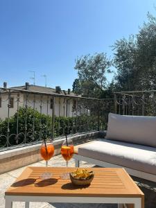 a table with two glasses on top of a balcony at Corte Impero Hotel & Restaurant in Affi