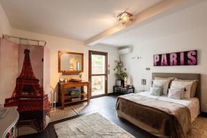 a bedroom with a paris sign on the wall and a bed at Villa Mare Monti in Lumio +37 photos