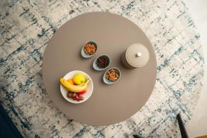 a table topped with a plate of fruit and nuts at Sama Hotels in Dakar