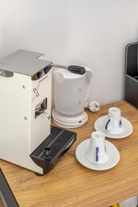 a coffee maker and two cups on a table at B&B La Piazzetta in Ischia Town