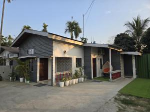 a house with a lot of plants in front of it at Camellia The Bungalow in Dibrugarh