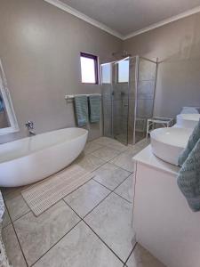 a bathroom with two sinks and a tub and a shower at Valley View the home with a view in Nottingham Road +29 photos