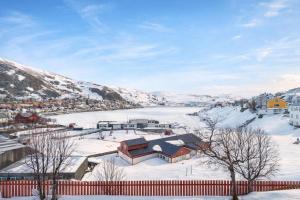 a town in the snow with a fence at Homestay Hammerfest - Central - Lakeview in Hammerfest