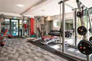 a gym with several treadmills and weights at Macdonald Frimley Hall Hotel & Spa in Camberley