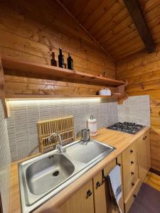 a kitchen with a sink and a stove at Etna Essence Chalet in Trecastagni +52 photos