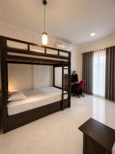 a bedroom with a bunk bed and a desk at Janri Villa in Tangalle +14 photos
