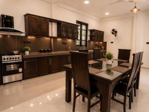 a kitchen with a table and chairs in a room at Janri Villa in Tangalle