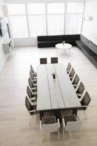 a white table and chairs in a room with windows at Himos Pitkäjärvi in Jämsä