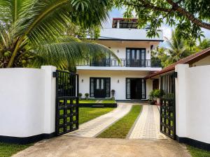 a house with a gate in front of it at Janri Villa in Tangalle