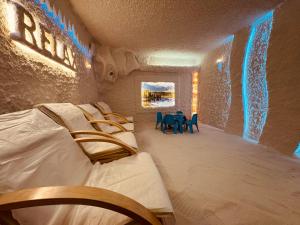 a room with a bed and a table and chairs at Spa Hotel Ata in Varshets