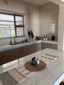 a kitchen with a table with a bowl on it at Pooltjie's Self-catering Overnight in Keetmanshoop +20 photos