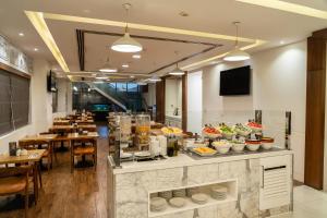 a restaurant with a buffet of food on a counter at Citymax Sharjah in Sharjah