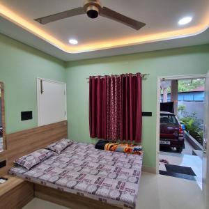 a bedroom with a bed and a red curtain at Royal Homestay Siliguri in Silīguri Junction