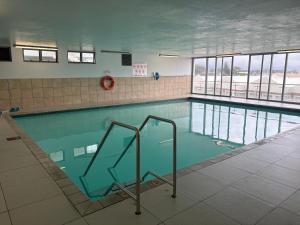a swimming pool with blue water in a building at Hibernian Towers 1503 in Strand