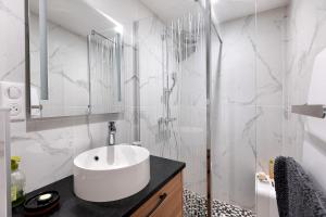 a bathroom with a sink and a shower at Les Iris - Maison Troglodytique in Trôo +24 photos