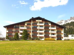 a large building with a grass field in front of it at Triangel A Freund in Parpan