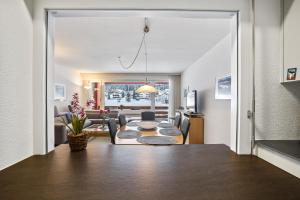 a living room with a table and a couch at Triangel A Freund in Parpan