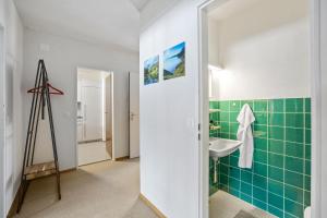 a bathroom with green tiles and a sink at Triangel A Freund in Parpan +21 photos