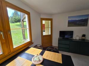 a dining room with a table and a window at Ferienwohnung Selva in Lenzerheide