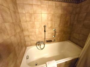 a bathroom with a bath tub with a towel at Ferienwohnung Selva in Lenzerheide +10 photos