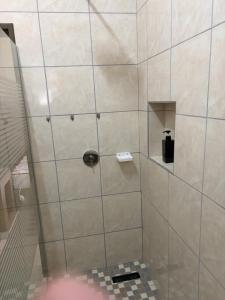 a shower with a glass door with a soap dispenser at Pooltjie's Self-catering Overnight in Keetmanshoop