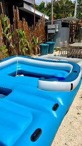 a blue and white boat sitting in a yard at Crossa Inn in Siquijor