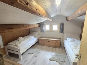 a room with two beds and a window in a house at Maiensäss Crapera in Lenzerheide +21 photos