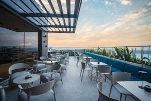 a restaurant with tables and chairs on a balcony at Sama Hotels in Dakar