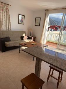 a living room with a couch and a table at VV Monica 33 "by AFCVacacional" in Puerto Naos